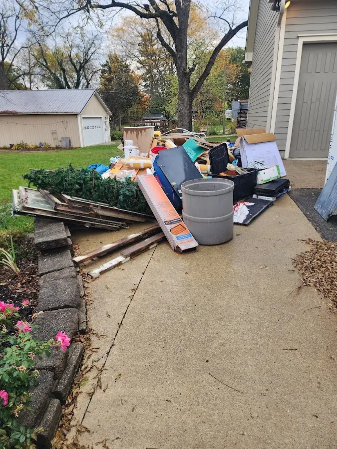 Dumpster being loaded with debris for Roofing Dumpster Rental in Charlestown